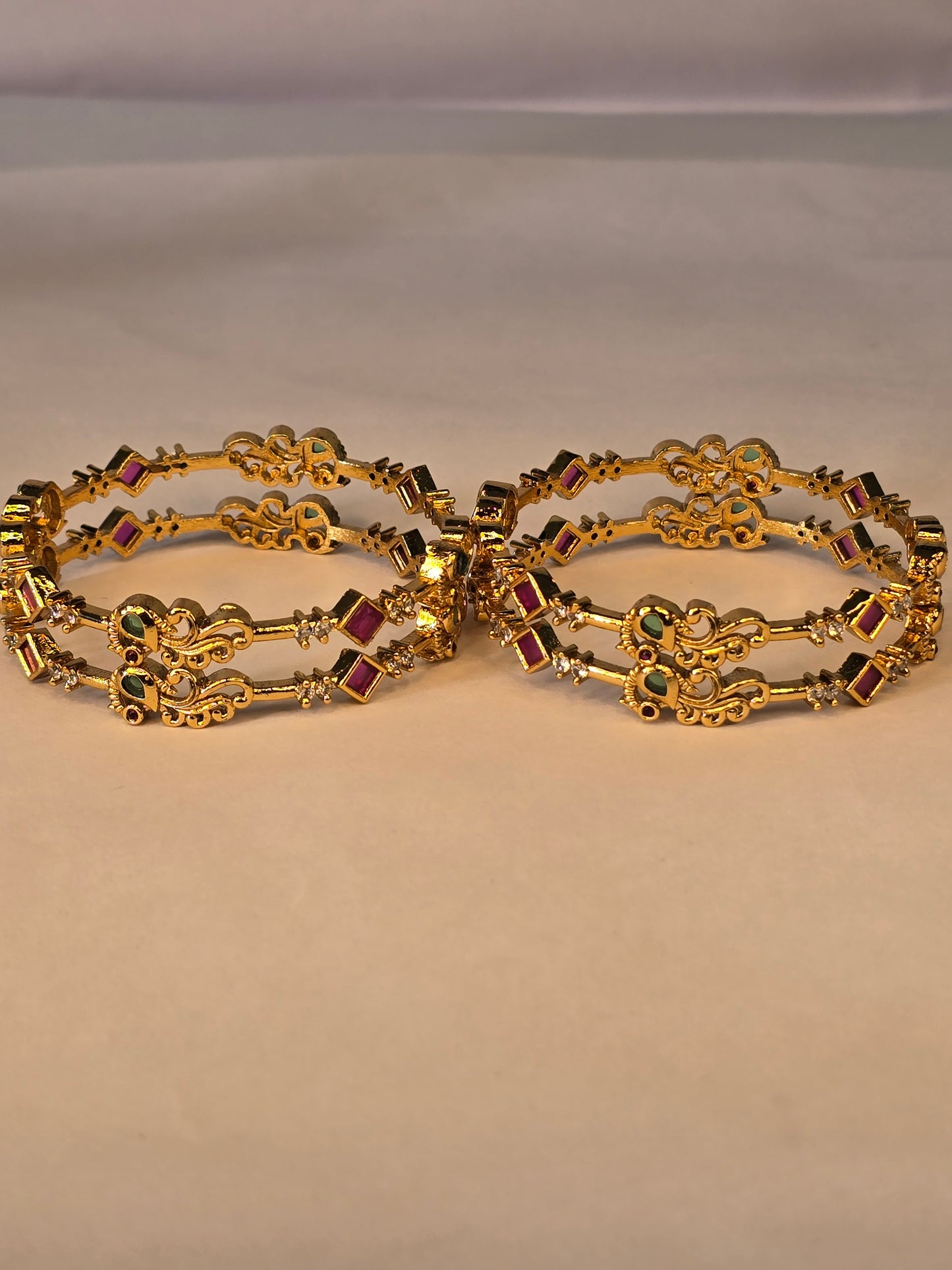 NERONI Gold-Plated Peacock Design Ruby & Emerald CZ Bangles – Royal Designer Edition (Pack of 4)