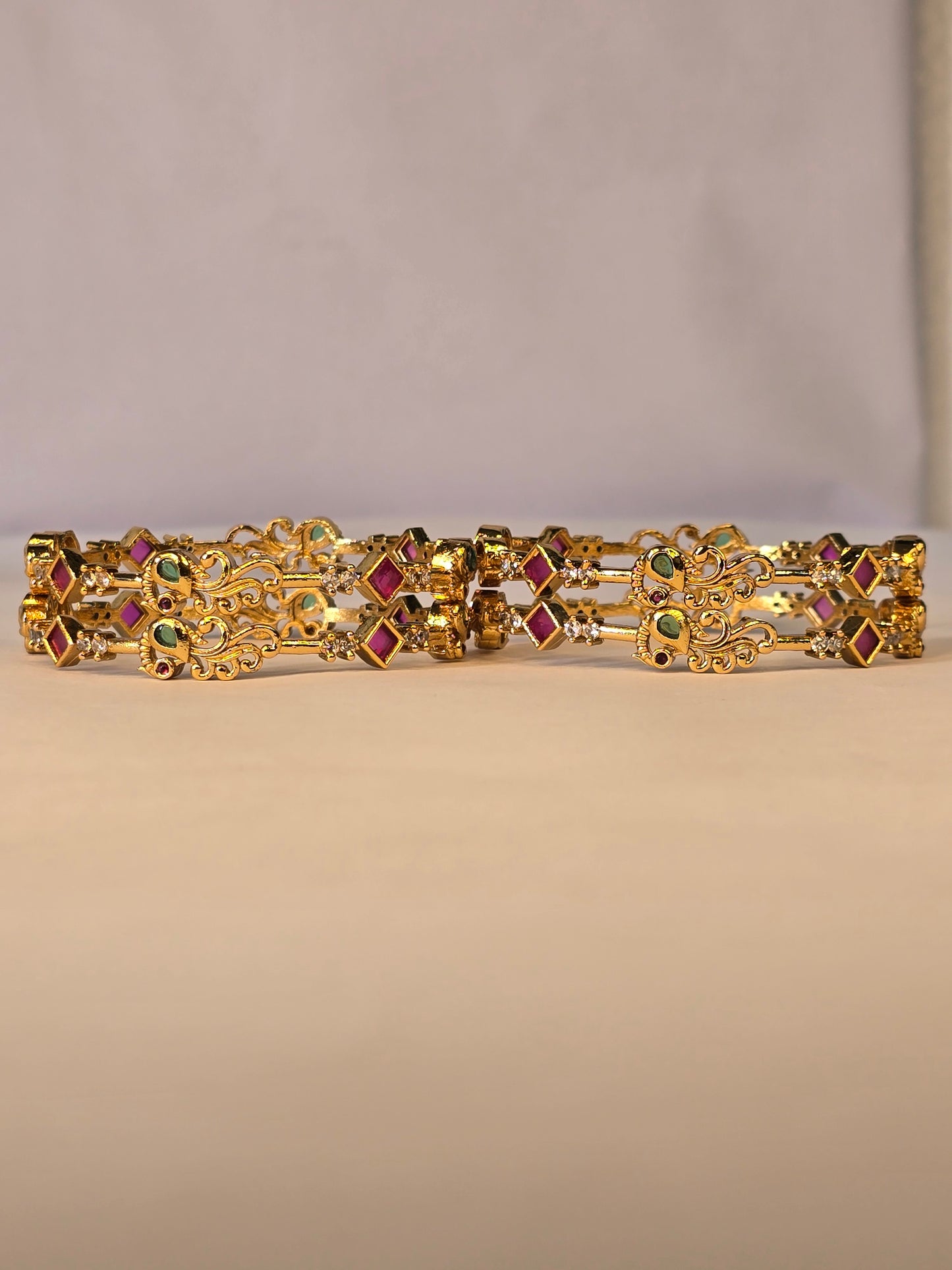 NERONI Gold-Plated Peacock Design Ruby & Emerald CZ Bangles – Royal Designer Edition (Pack of 4)