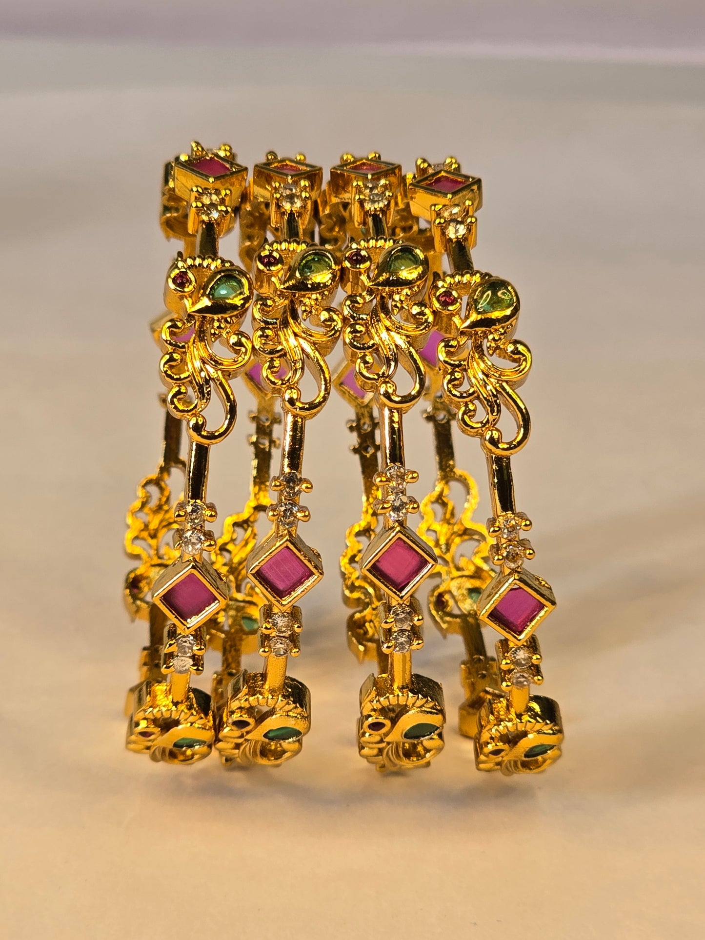 NERONI Gold-Plated Peacock Design Ruby & Emerald CZ Bangles – Royal Designer Edition (Pack of 4)