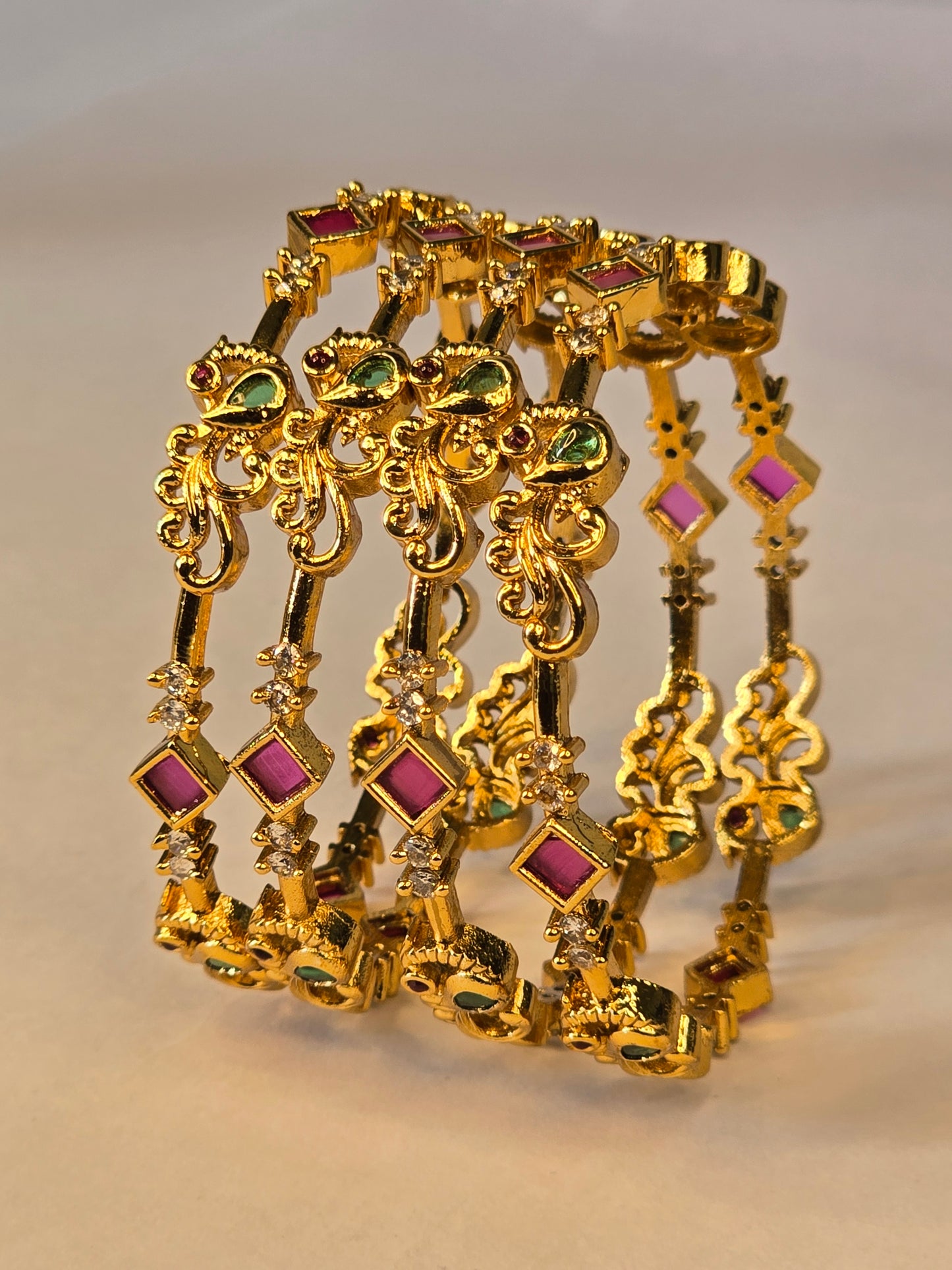 NERONI Gold-Plated Peacock Design Ruby & Emerald CZ Bangles – Royal Designer Edition (Pack of 4)