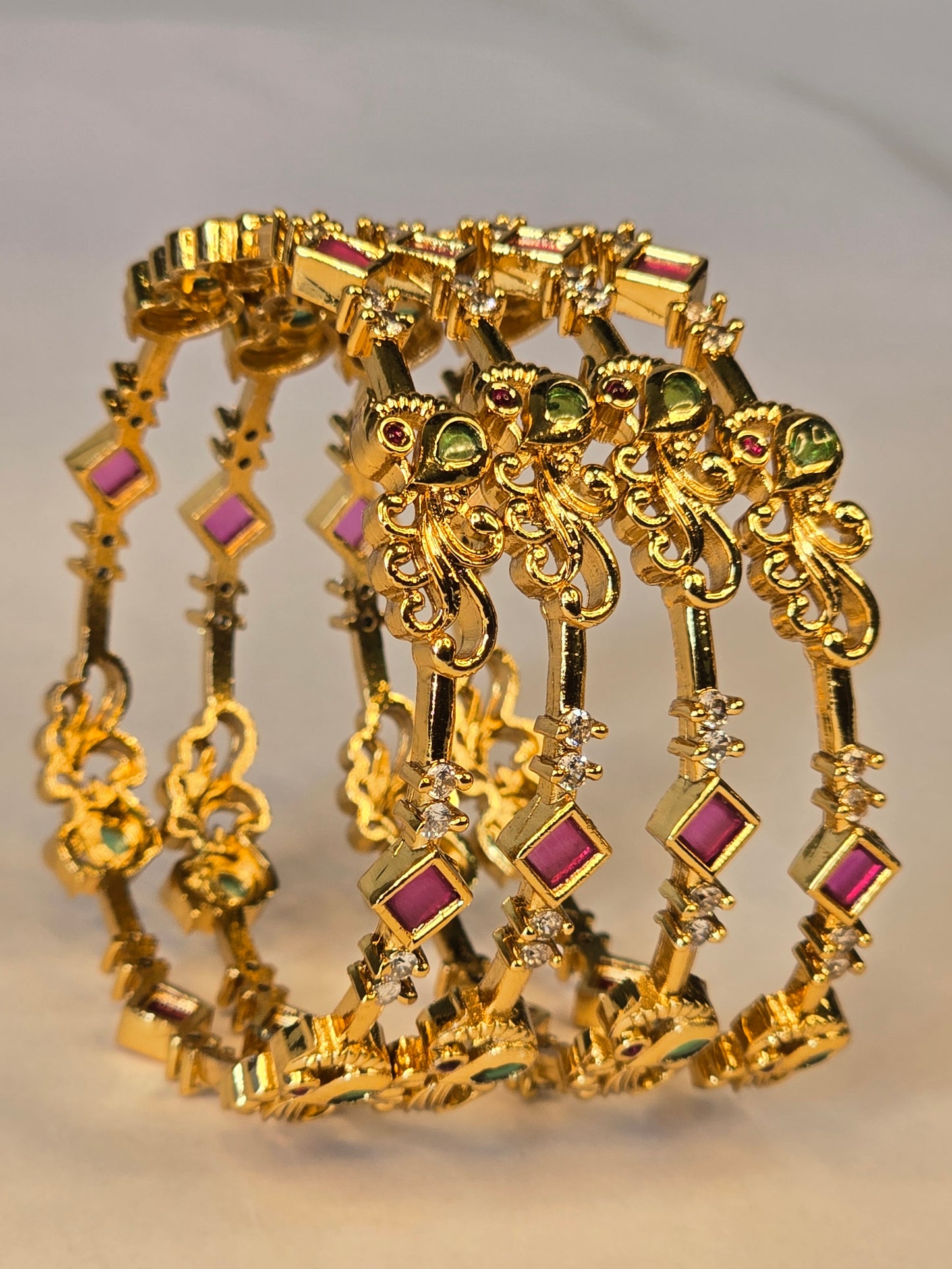 NERONI Gold-Plated Peacock Design Ruby & Emerald CZ Bangles – Royal Designer Edition (Pack of 4)