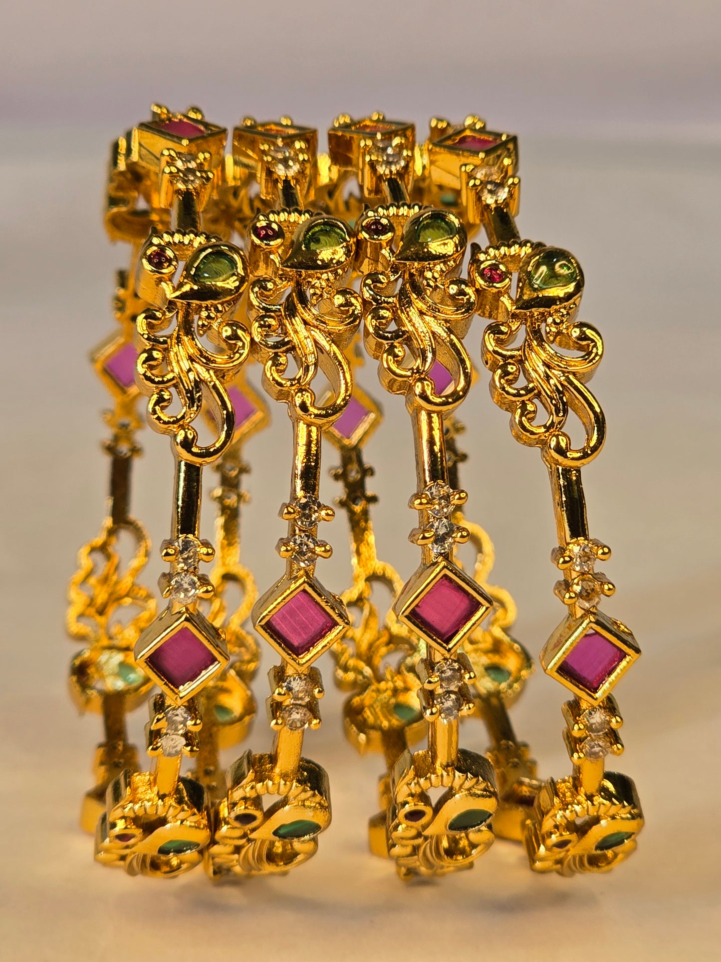 NERONI Gold-Plated Peacock Design Ruby & Emerald CZ Bangles – Royal Designer Edition (Pack of 4)
