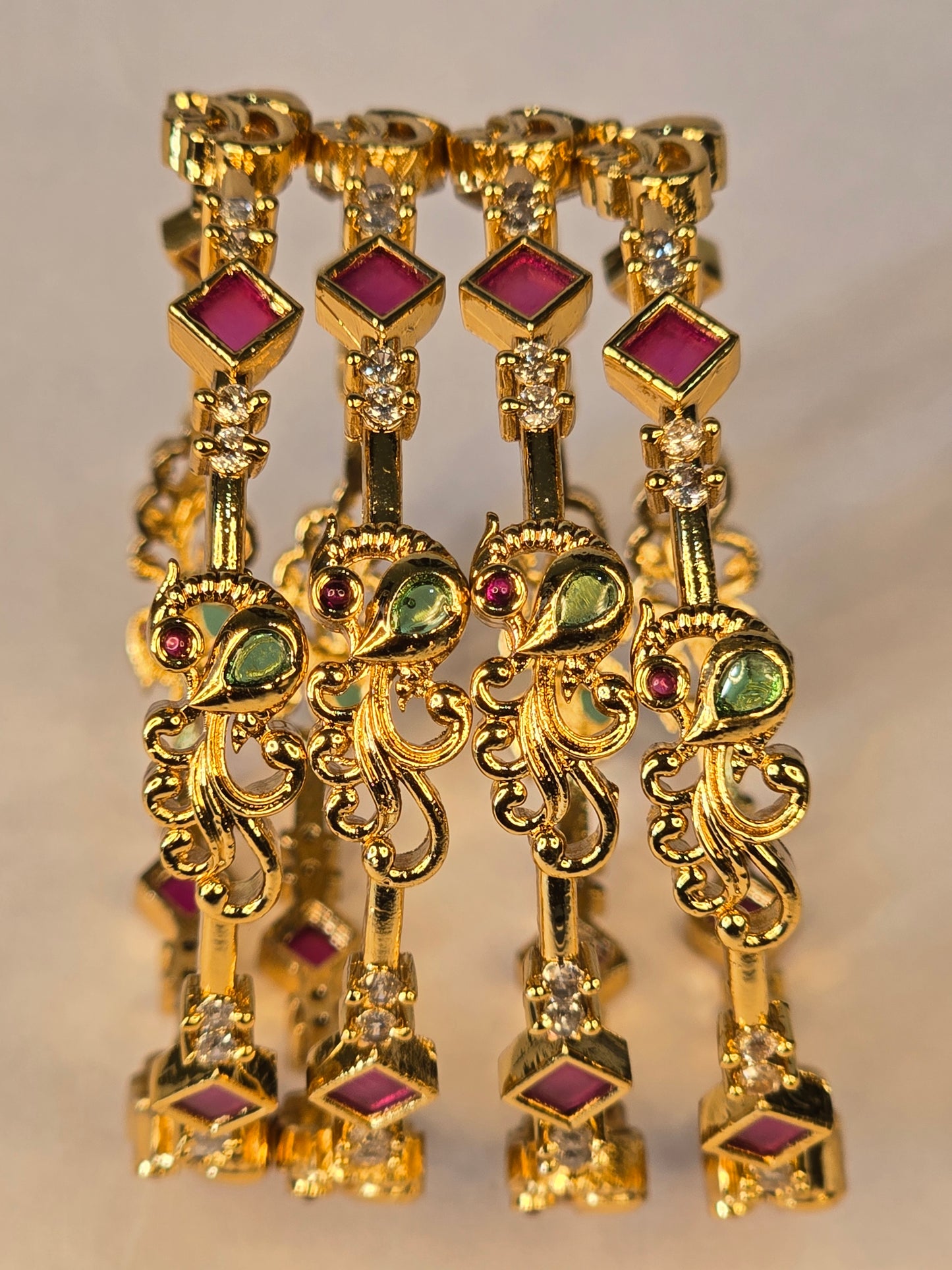 NERONI Gold-Plated Peacock Design Ruby & Emerald CZ Bangles – Royal Designer Edition (Pack of 4)